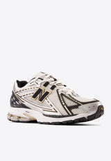 1906R Low-Top Sneakers in Metallic Silver with Metallic Gold